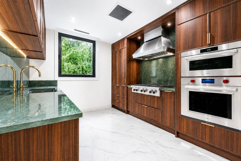 Wok Kitchen With Dark Wood Cabinetry And Green Stone